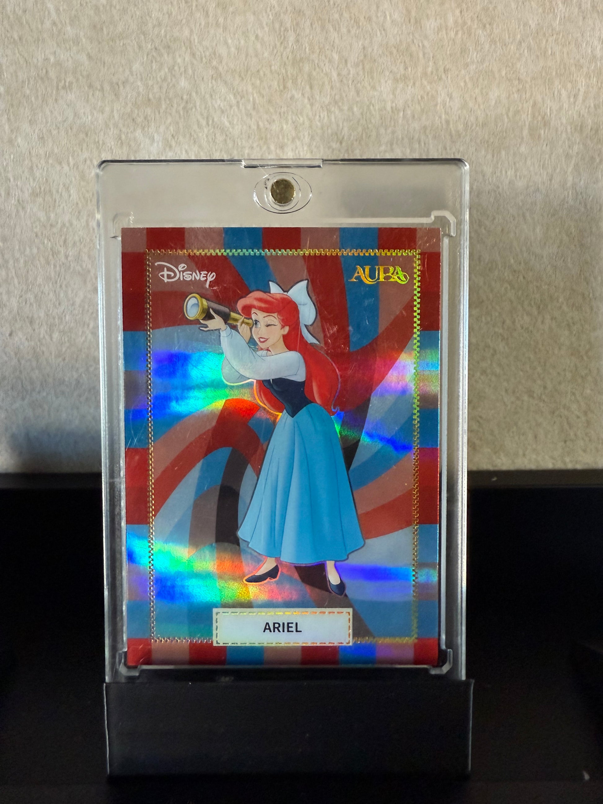 Disney AURA – Ariel Holographic Card (Red/Blue Swirl Background)